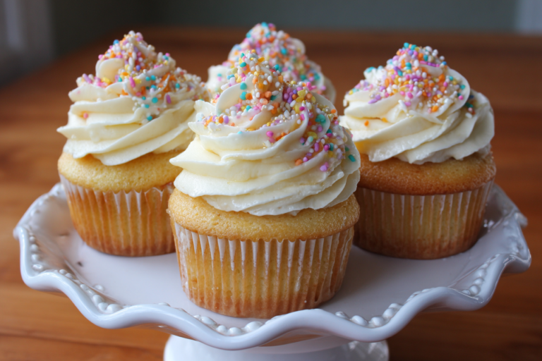 Soft Bakery-Style Vanilla Cupcakes with Silky Creamy Frosting and Colorful Sprinkles
